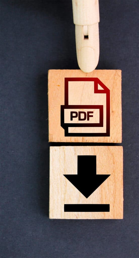 Holzfinger zeigt auf Block mit PDF-Symbol